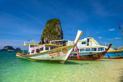 KRABI, THAILAND- MARCH 2018: Long tail boats and cliff rock in azure water, Ko Rang Nok, Ao Phra Nang Beach, Ao Nang, Krabi, Thailand.