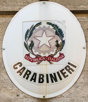 coat of arms of the carabinieri in front of the barracks