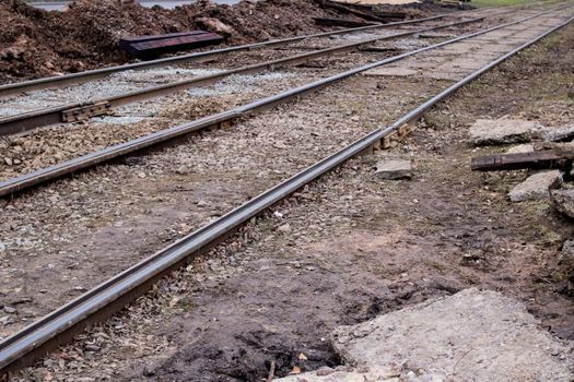 Sand on repair work on tram rails close up