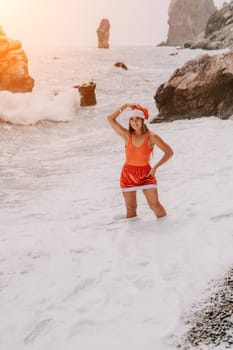 Woman travel sea. Young Happy woman in a long red dress posing on a beach near the sea on background of volcanic rocks, like in Iceland, sharing travel adventure journey