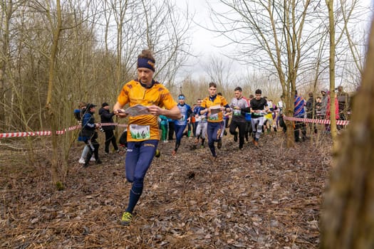 Grodno, Belarus - 26 March, 2023: Mass start of the relay at competitions in outdoor orienteering Grodno Forest Day. Belarus, hobby sport.