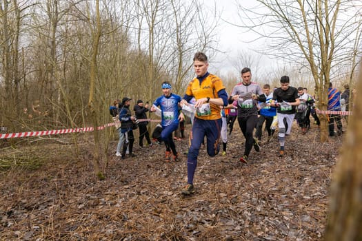 Grodno, Belarus - 26 March, 2023: Mass start of the relay at competitions in outdoor orienteering Grodno Forest Day. Belarus, hobby sport.