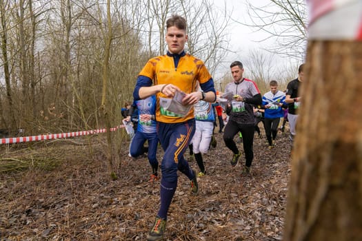 Grodno, Belarus - 26 March, 2023: Mass start of the relay at competitions in outdoor orienteering Grodno Forest Day. Belarus, hobby sport.