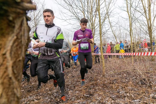 Grodno, Belarus - 26 March, 2023: Mass start of the relay at competitions in outdoor orienteering Grodno Forest Day. Belarus, hobby sport.