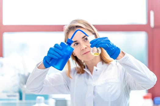 young female scientist is testing a new medicine for the medical industry in a research laboratory.