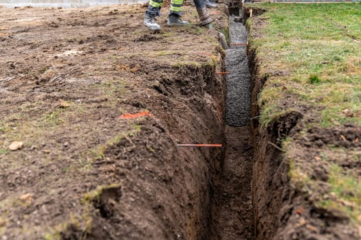 cementing the foundation in the ground when building a house.