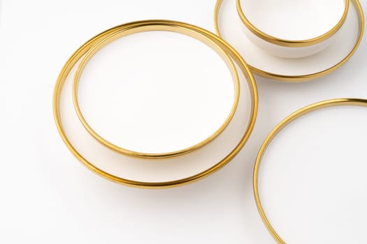 A set of white and brown ceramic plate and cup on a white background