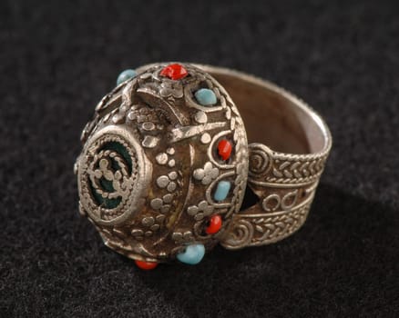 A Vintage, fancy ring with precious, colorful stones isolated on a black background