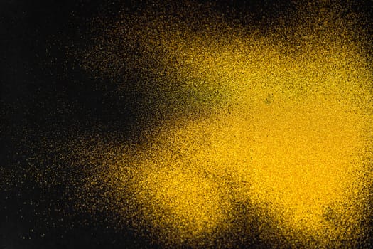 A minimal golden sand texture on a black background