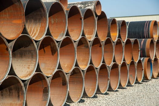 Lines of oilfield large streel pipes in an industrial construction area