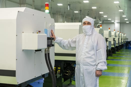 The workers in the workshop with molding machine for the production of medical production