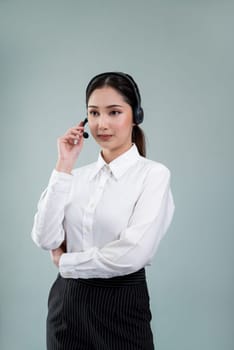 Attractive asian female call center operator with happy smile face advertises job opportunity on empty space, wearing a formal suit and headset on customizable isolated background. Enthusiastic