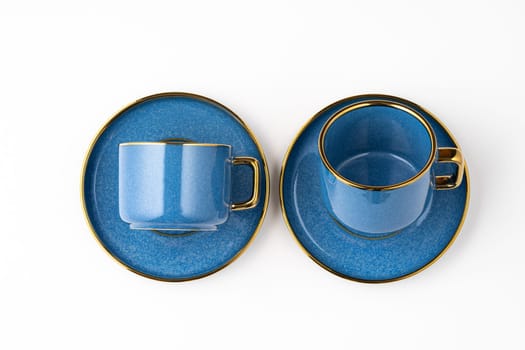 A set of blue ceramic plates and cup on a white background. Top view
