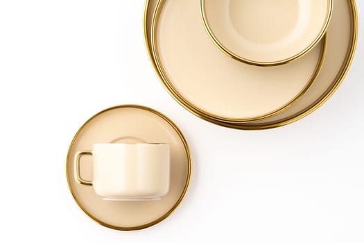 A Set of light brown ceramic plate and cup on a white background. Top view