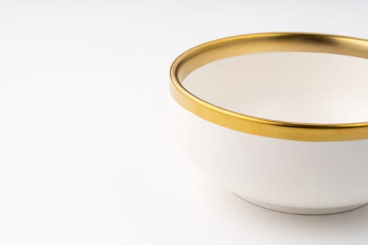 A white and brown ceramic bowl on a white background