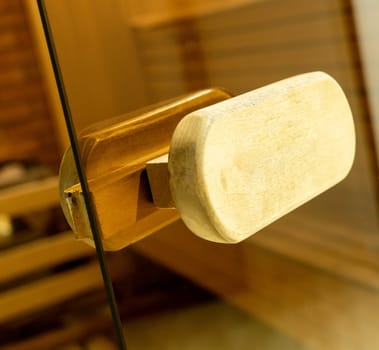 A closeup of a door handle of the sauna in the sports complex