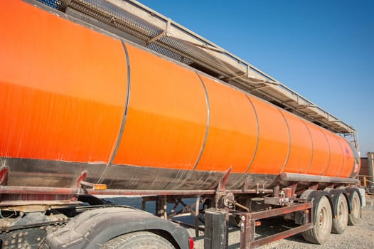 A closeup gas red tanker truck at an industrial construction site