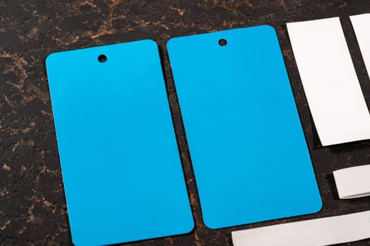 A closeup shot of blank blue and white paper tags for clothing sales