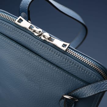 A closeup shot of a luxury blue leather bag