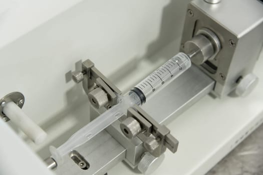 A closeup of the production and testing of medical syringes and droppers