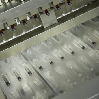 A closeup of the production of medical syringes