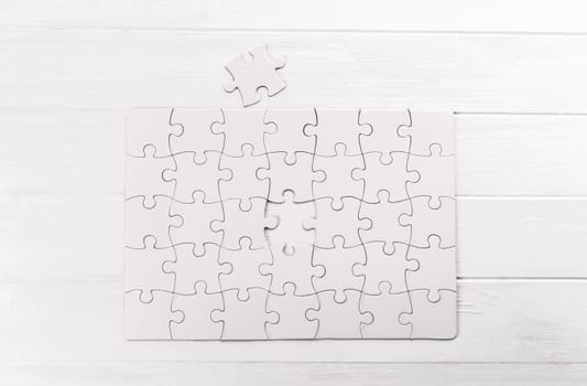 Top view of white jigsaw puzzle