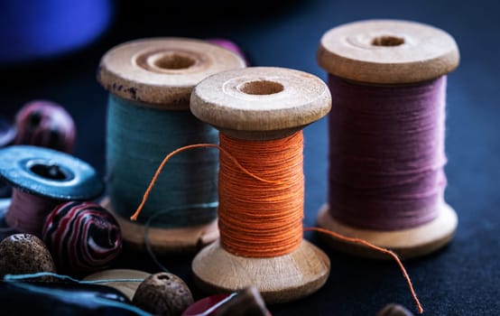 Colorful retro threads on wooden bobbins