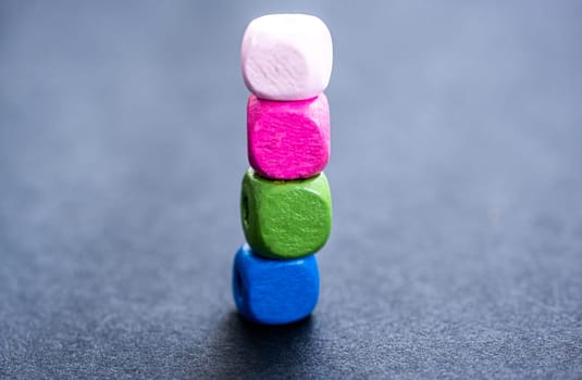 Stack of bright wooden beads on gray background