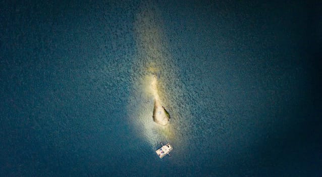 Island and touristic raft in middle of Synevir Lake, aerial view