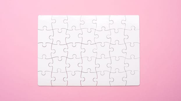 Blank finished rectangular puzzle on pink background