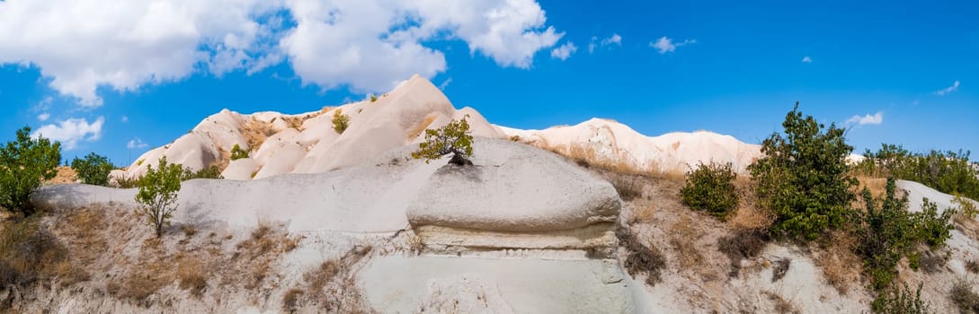 Panoramic view of sand mountain under clear blue sky in Cappadocia, Turkey