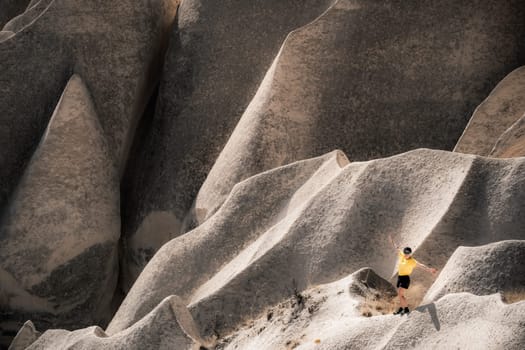 Woman tourists standing on stony mountain in Cappadocia, Turkey