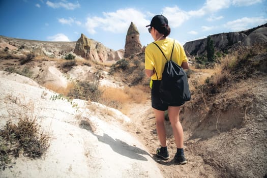 Rear view of woman trekking in Cappadocia mountains, Turkey