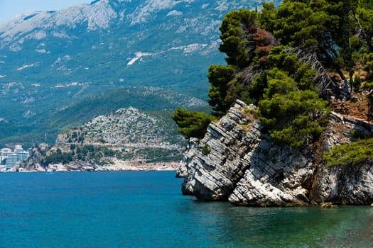 Beautiful Budva in Montenegro from Adriatic sea view. Mountains with forest in Mediterranean coastline