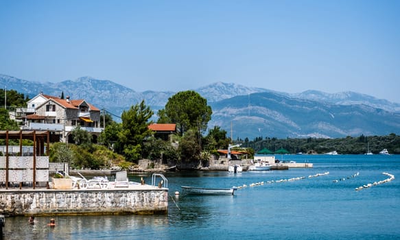 Beautiful Mediterranean architecture in Montenegro from Adriatic sea view. Scenic town with mountains on background