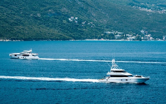 Yachts in Adriatic sea, Montenegro. Scenic view on mountains, luxury boats and Mediterranean landscapes