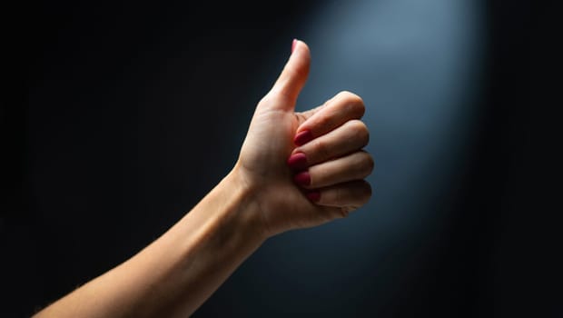 Hand shows sign fine holding finger up. Concept of gesture communication