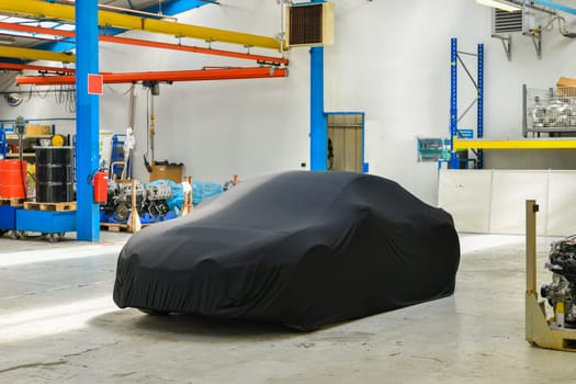 New covered car model at the factory before the presentation