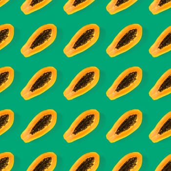 Fresh ripe papaya seamless pattern on green background. Tropical abstract background. Top view. Creative design, minimal flat lay concept. Trend tropical fruit food background pattern