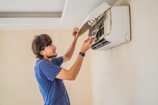 technician service removing air filter of the air conditioner for cleaning.