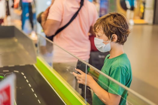 Adorable cute little child playing with toy on remote control, in the mall. Happy kid boy having fun. Leisure, lifestyle for kids concept.