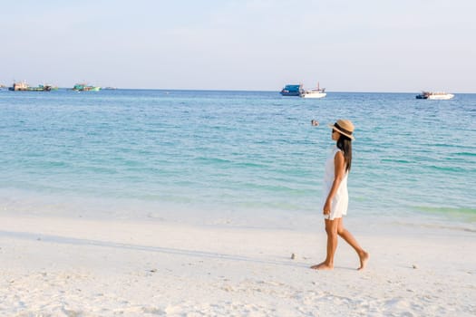 Asian women walking on the beach during sunset at Ko Lipe Island Thailand