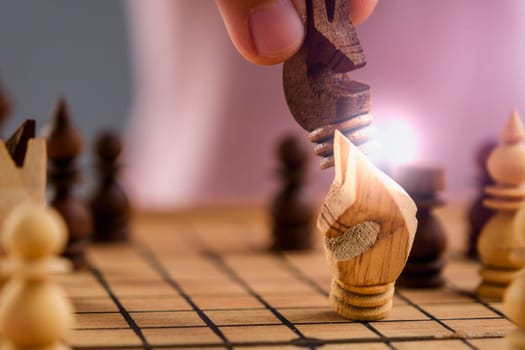 Close-up of businessman hands playing chess game. Concept of business strategy and tactic.