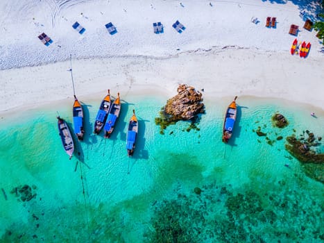 drone view at the beach of Koh Lipe island in Thailand, longtail boats in the ocean of Ko Lipe