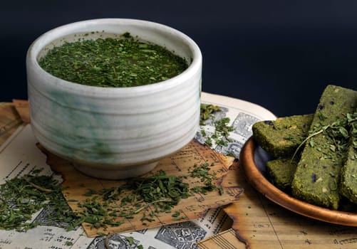 Bangkok, Thailand - Mar 17, 2023 : Enjoy with A Cup of Hemp Tea (CBD herbal tea) is served with the Homemade Cannabis Snack Sticks on the Old Music Notebook. The Concept of Relaxation and the Happiness, Vintage style, Space for text.