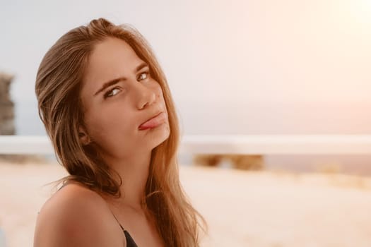 Happy woman portrait in cafe. Boho chic fashion style. Outdoor photo of young happy woman with long hair, sunny weather outdoors sitting in modern cafe