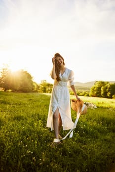 a woman in a long, light dress stands in a chamomile field at sunset and closes herself from the camera with her hands. High quality photo