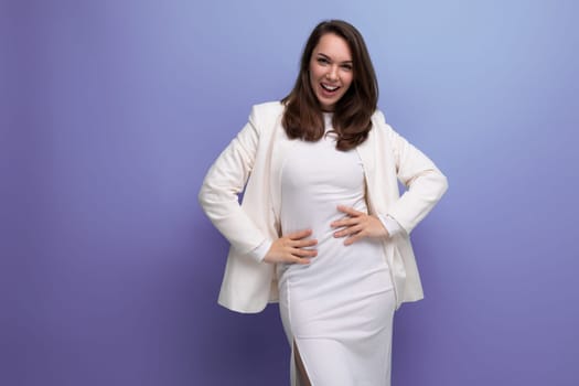 portrait of a well-groomed dark-haired business young woman in a white elegant dress and jacket with copy space.