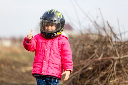 Little girl in a motorcycle helmet