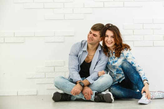 Portrait of young couple smiling on white background